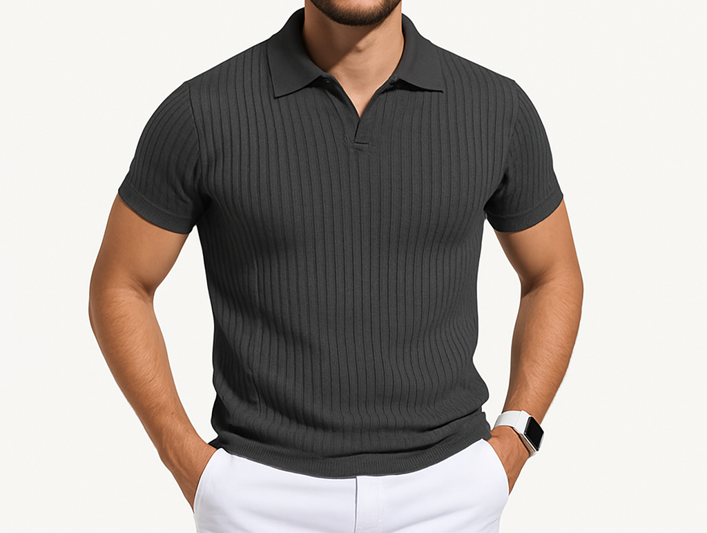 Man wearing a dark gray ribbed polo shirt and white pants on a light gray background
